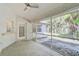 Relaxing screened porch overlooking backyard with ceiling fan and access door at 740 Citrus Rd, Venice, FL 34293