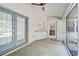 Covered screened porch with ceiling fan, concrete flooring, and access door at 740 Citrus Rd, Venice, FL 34293