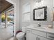 Powder room with single vanity, toilet and view of pool area at 7484 Ripetta St, Sarasota, FL 34240