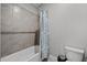Bathroom with tub and shower, tile surround, and neutral color palette at 7484 Ripetta St, Sarasota, FL 34240