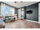 bedroom with a desk and a TV, featuring wood floors at 7484 Ripetta St, Sarasota, FL 34240
