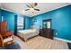 Bright bedroom with a queen-size bed, wood floors, and a built-in desk at 7484 Ripetta St, Sarasota, FL 34240