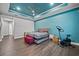 Main bedroom with king bed, exercise bike, and ceiling fan at 7484 Ripetta St, Sarasota, FL 34240