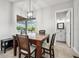 Bright breakfast nook features a table with four chairs, offering a view of the backyard at 7484 Ripetta St, Sarasota, FL 34240