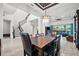 Elegant dining room with a large table and views into the living room at 7484 Ripetta St, Sarasota, FL 34240