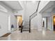 Bright and spacious entryway with tile floors and elegant staircase at 7484 Ripetta St, Sarasota, FL 34240