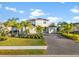 Two-story house with gray walls, tile roof, and a three-car garage at 7484 Ripetta St, Sarasota, FL 34240