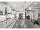 White kitchen with stainless steel appliances and an expansive island at 7484 Ripetta St, Sarasota, FL 34240