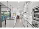 Modern kitchen with white cabinets, stainless steel appliances, and a large island at 7484 Ripetta St, Sarasota, FL 34240