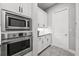 Kitchen boasts built-in microwave and double oven, along with white shaker cabinets at 7484 Ripetta St, Sarasota, FL 34240