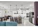 Open kitchen with white cabinets, stainless steel appliances, and an island at 7484 Ripetta St, Sarasota, FL 34240