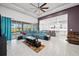 Open living room showcasing teal sectional sofa and a view into the kitchen at 7484 Ripetta St, Sarasota, FL 34240