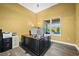Home office with large desk, window, and wood-look flooring at 7484 Ripetta St, Sarasota, FL 34240