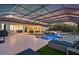 Large, rectangular pool with a covered patio and lounge area at 7484 Ripetta St, Sarasota, FL 34240