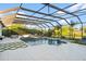 Relaxing pool area with covered patio, fire pit, and ample seating at 7484 Ripetta St, Sarasota, FL 34240
