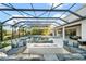 Resort-style backyard oasis with a covered lanai and fire pit at 7484 Ripetta St, Sarasota, FL 34240