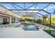 Large, rectangular pool with a covered patio and lounge area at 7484 Ripetta St, Sarasota, FL 34240
