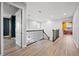 Upstairs hallway with hardwood floors and elegant staircase at 7484 Ripetta St, Sarasota, FL 34240