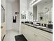 Clean bathroom with double sinks and dark granite countertops at 804 Triano Cir # 804, Venice, FL 34292