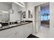 Double vanity bathroom with granite countertops and large mirrors at 804 Triano Cir # 804, Venice, FL 34292