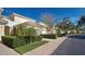 Light yellow building with white garage doors and neatly trimmed hedges at 804 Triano Cir # 804, Venice, FL 34292