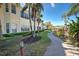 Building exterior showcasing a walkway and lush landscaping at 804 Triano Cir # 804, Venice, FL 34292