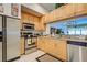Modern kitchen with light wood cabinets and stainless steel appliances at 804 Triano Cir # 804, Venice, FL 34292