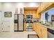 Modern kitchen with light wood cabinets and stainless steel appliances at 804 Triano Cir # 804, Venice, FL 34292
