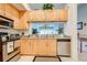 Modern kitchen with light wood cabinets and stainless steel appliances at 804 Triano Cir # 804, Venice, FL 34292