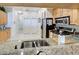 Granite countertops and stainless steel appliances in this well-equipped kitchen at 804 Triano Cir # 804, Venice, FL 34292
