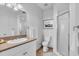 Well-lit bathroom with a single sink, toilet, and shower at 8230 Harborside Cir, Englewood, FL 34224