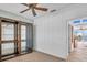 Bedroom with glass cabinet and access to balcony at 8230 Harborside Cir, Englewood, FL 34224