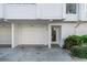 White garage door and entrance to unit at 8230 Harborside Cir, Englewood, FL 34224