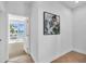 Clean hallway with access to balcony and artwork at 8230 Harborside Cir, Englewood, FL 34224