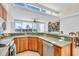 Open concept kitchen with island and stainless steel appliances at 8230 Harborside Cir, Englewood, FL 34224