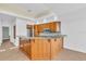 L-shaped kitchen with wood cabinets and granite countertops at 8230 Harborside Cir, Englewood, FL 34224