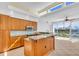 Modern kitchen with wood cabinets and a breakfast bar at 8230 Harborside Cir, Englewood, FL 34224