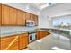 Modern kitchen with wood cabinets and granite countertops at 8230 Harborside Cir, Englewood, FL 34224