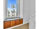 Built-in wooden cabinets under a large window overlooking the community at 8230 Harborside Cir, Englewood, FL 34224