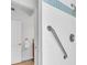 Accessible shower with grab bar and light blue tile accents at 8230 Harborside Cir, Englewood, FL 34224