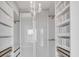 Spacious walk-in closet with built-in shelving and drawers at 8230 Harborside Cir, Englewood, FL 34224