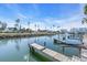 Calm water, wooden docks, boats, and lush tropical vegetation at 8230 Harborside Cir, Englewood, FL 34224