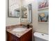 Well-lit bathroom featuring a granite vanity, modern fixtures, and colorful artwork, creating a vibrant and inviting space at 854 Bird Bay Way # 190, Venice, FL 34285