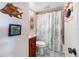 Unique bathroom with stylish fish-themed decor and a patterned shower curtain, adding a touch of creativity at 854 Bird Bay Way # 190, Venice, FL 34285