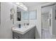 Modern bathroom with a stylish vanity, gray cabinets, and a glass-enclosed shower for a spa-like experience at 854 Bird Bay Way # 190, Venice, FL 34285