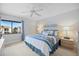 Cozy bedroom features a comfortable bed, ceiling fan, and large window with pleasant natural light at 854 Bird Bay Way # 190, Venice, FL 34285