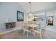 Cozy dining area featuring a charming table and chairs, complemented by a wine rack and views into the kitchen at 854 Bird Bay Way # 190, Venice, FL 34285