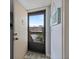 Bright entryway featuring a storm door leading to an open view and charming coastal-themed decor at 854 Bird Bay Way # 190, Venice, FL 34285