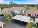 Exterior aerial view of a well-maintained condo with a carport, surrounded by lush landscaping at 854 Bird Bay Way # 190, Venice, FL 34285