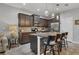 Modern kitchen with dark cabinetry, granite countertops, and stainless steel appliances at 8634 Palmer Park Cir, Sarasota, FL 34238